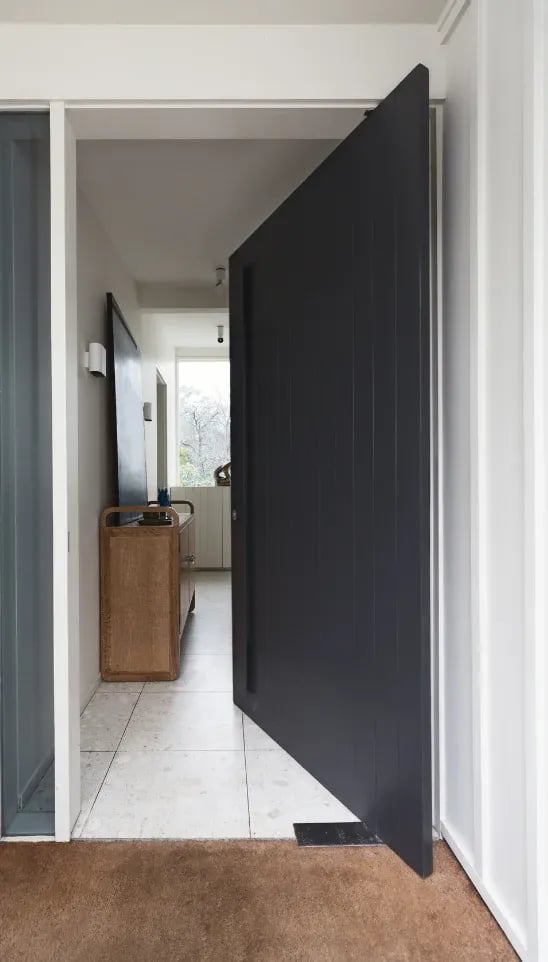 Townhouse entrance with a custom pivot door