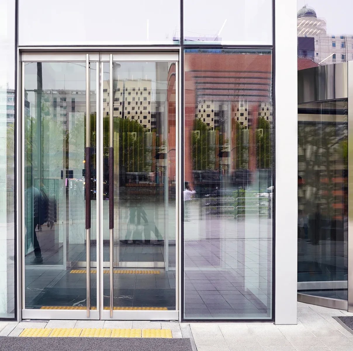 Modern glass building entrance with reflections