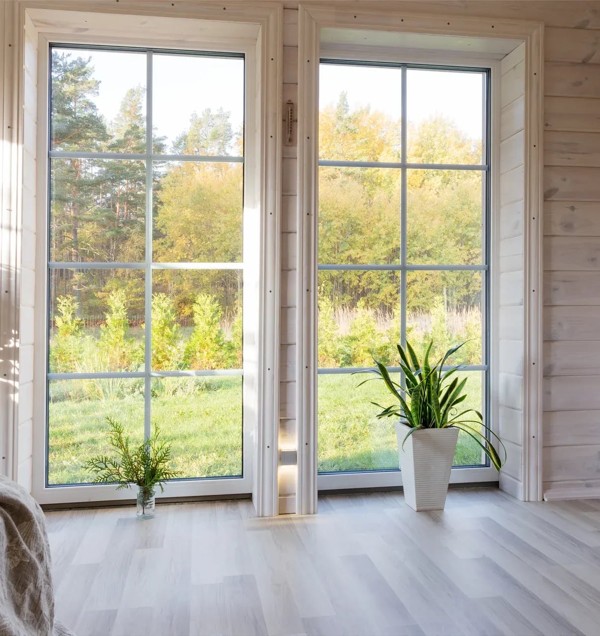 Bright interior room of a wooden house with a large window