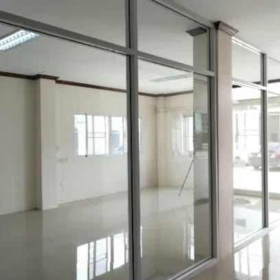 Detail view of a modern tilt-slide aluminum glass door system