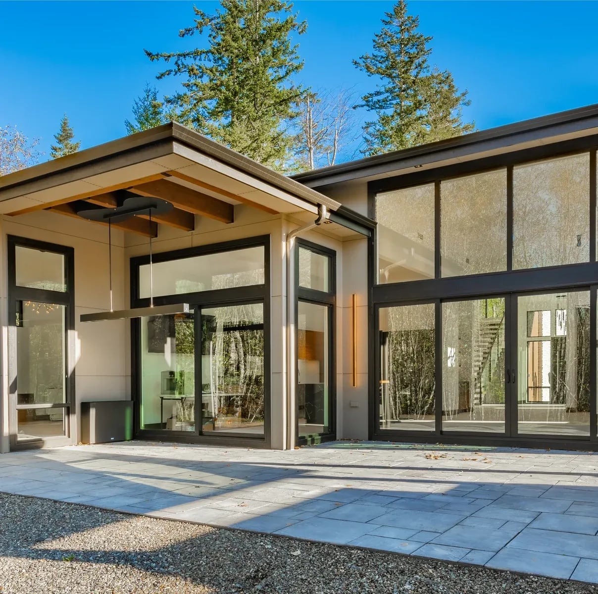 Contemporary modern home exterior with black-framed impact windows