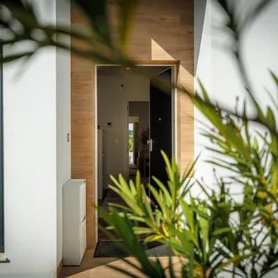 Villa entrance with a frosted glass pivot door