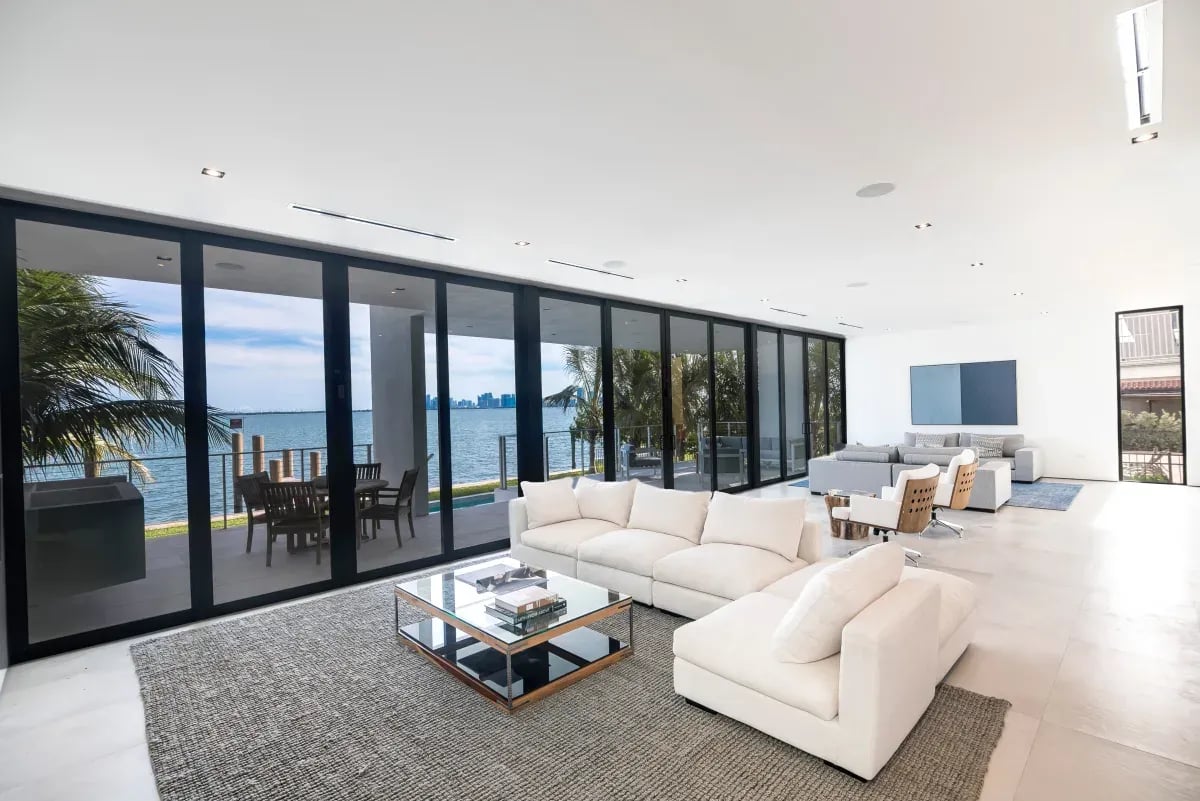 Waterfront home with wall-to-wall impact sliding glass doors